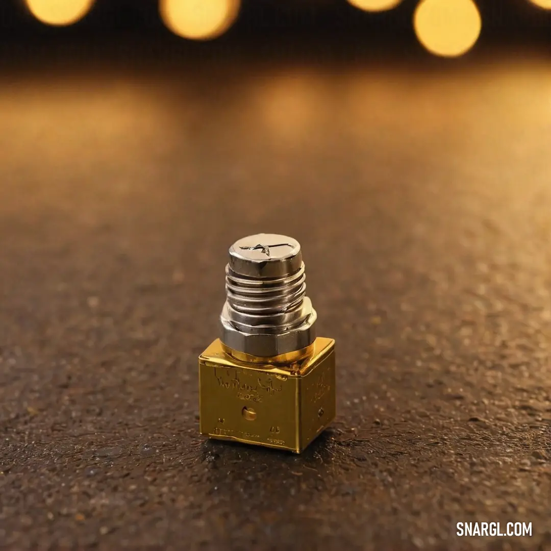 A small metallic object glimmers on a well-worn table amidst a backdrop of soft lighting, suggesting a story yet to be told about its origins and uses.