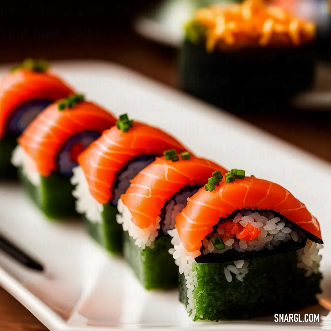 Plate of sushi with chopsticks on it and a fork on the side of the plate