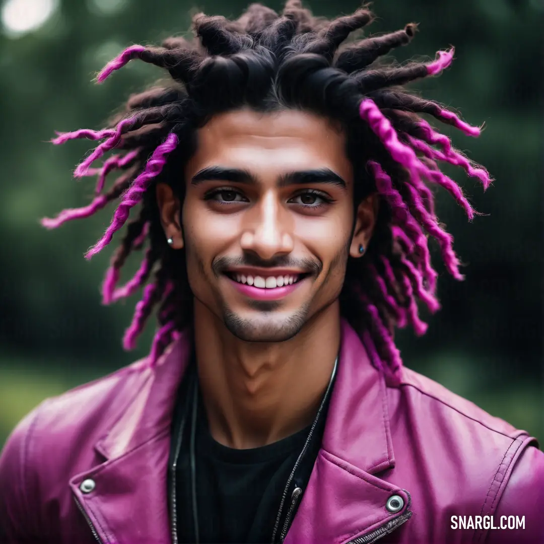 Man with dreadlocks and a leather jacket smiling at the camera with a smile on his face. Example of Sana color.
