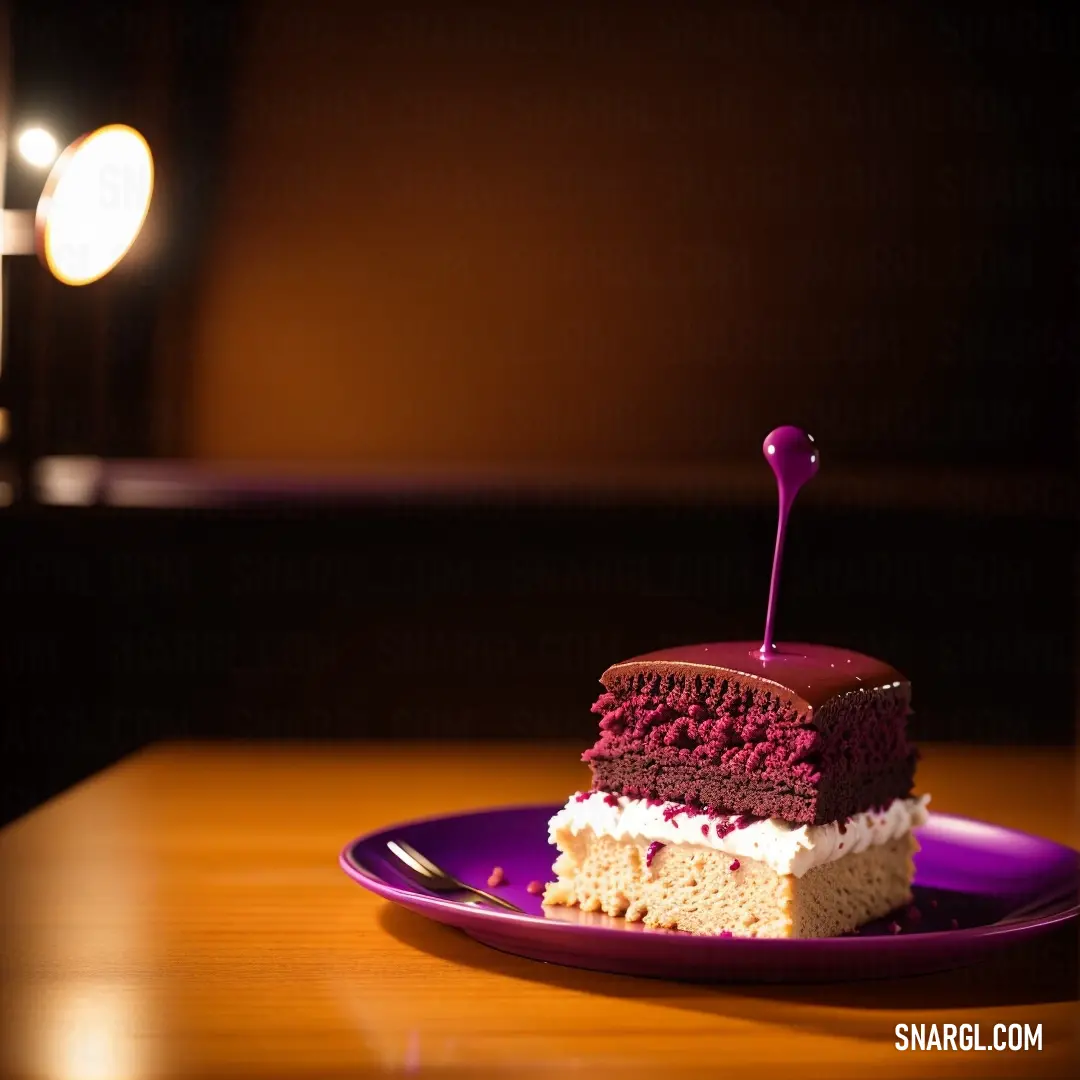 Piece of cake on a purple plate on a table with a light in the background. Example of Sana color.