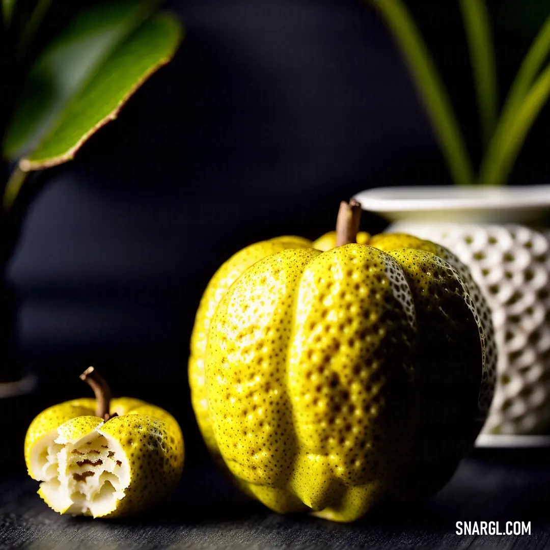 Close up of a fruit on a table near a potted plant