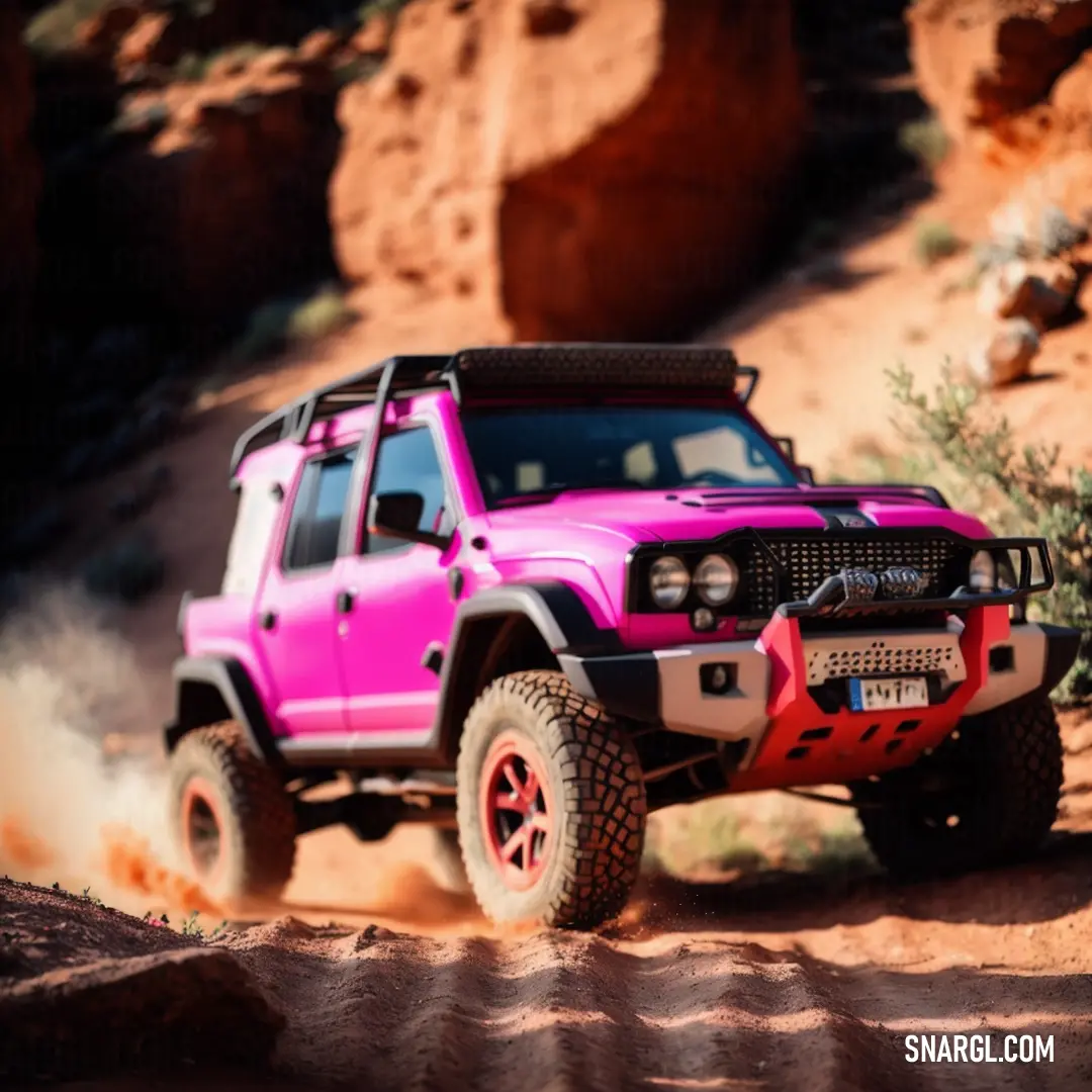 Pink jeep driving down a dirt road in the desert with rocks in the background and a red rock outcropping