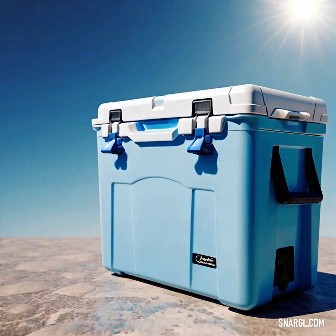 Blue cooler on top of a sandy beach under a blue sky with the sun shining on it. Example of #87CEEB color.