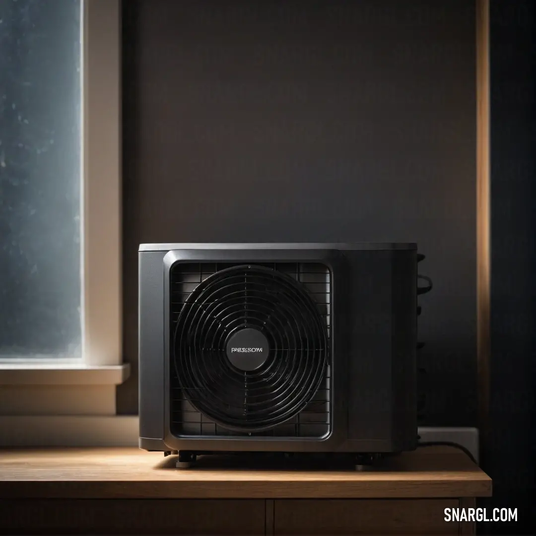 An elegant black and silver air conditioner perfectly set on a sleek table by a window, showcasing modern design while ensuring a refreshing atmosphere within the beautifully lit room.