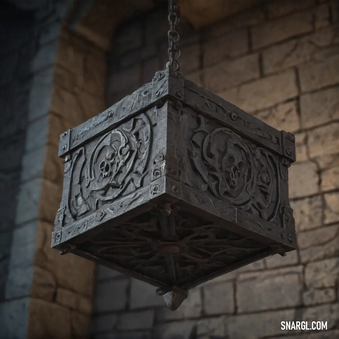 A unique hanging light fixture featuring a skull and cross design on its side, casting a soft glow against the backdrop of a textured brick wall. The light's color has a muted, cool tone, blending shades of gray and steel blue for a subtle industrial aest