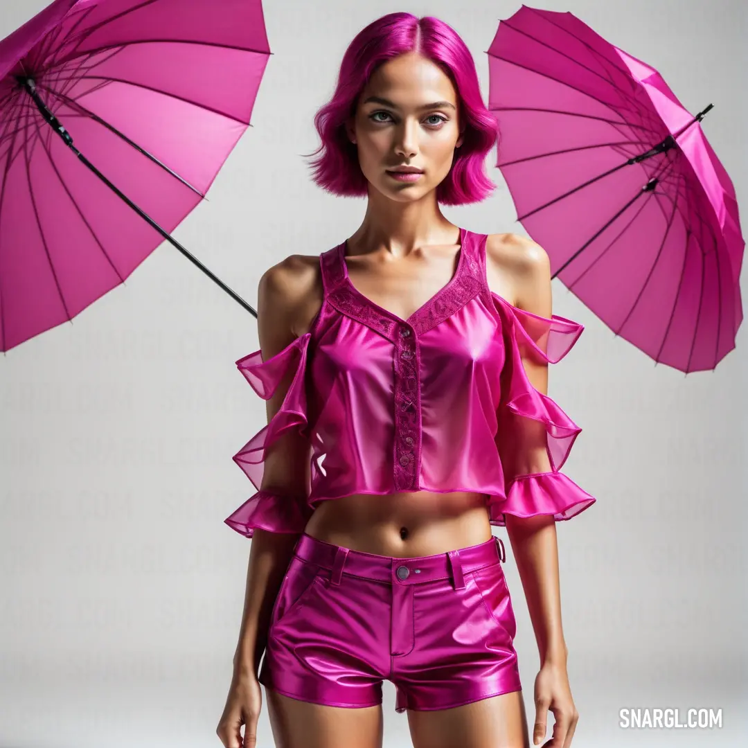 Woman with pink hair and a pink top holding two pink umbrellas in her hands and posing for a picture