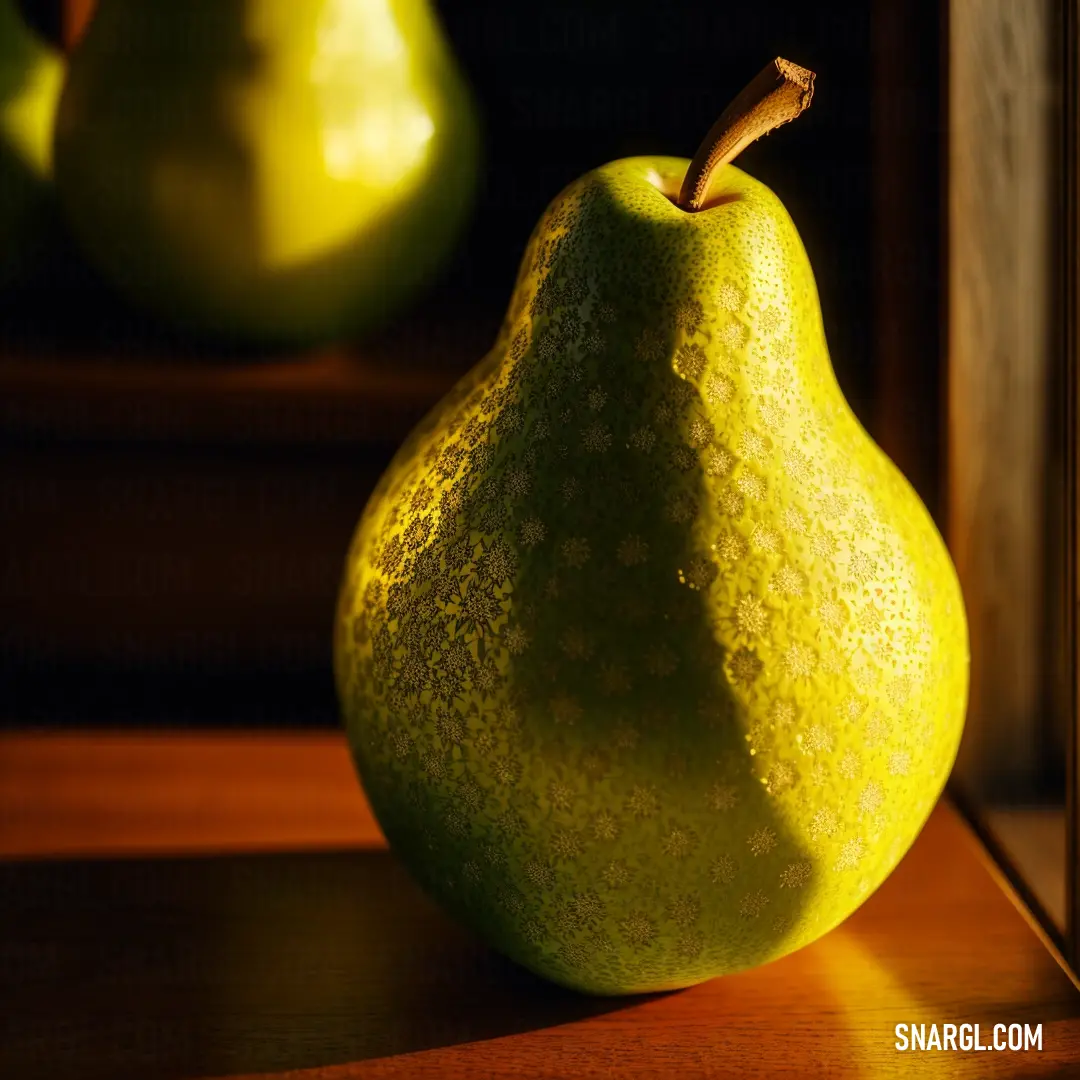 Pear on a table next to a mirror and a pear in the background with a shadow of a pear