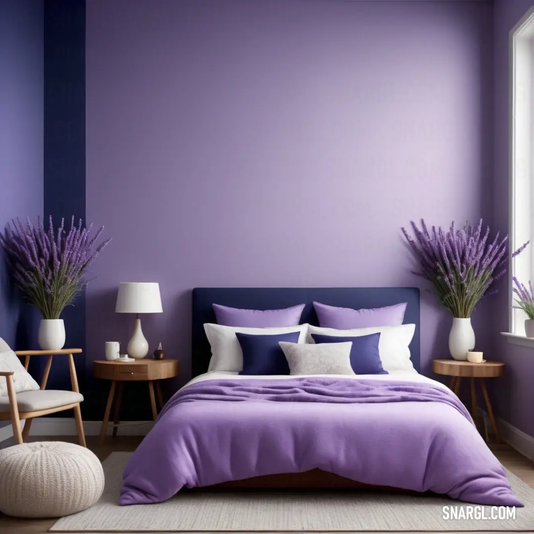 Bedroom with a purple wall and a bed with purple sheets and pillows and a chair and table with two lamps. Color RGB 208,240,192.