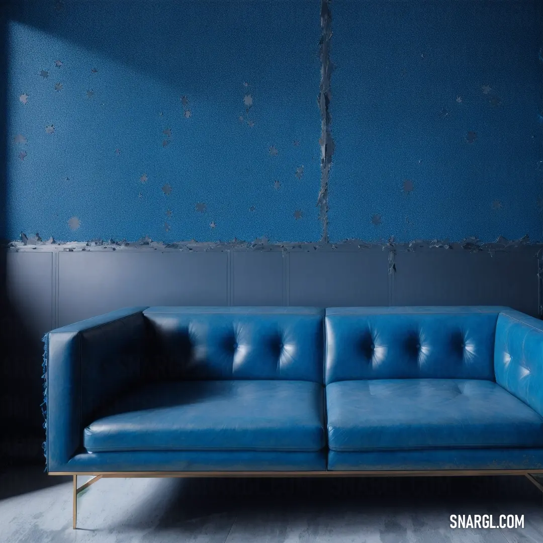 Blue couch in front of a blue wall with peeling paint on it's walls and a metal frame