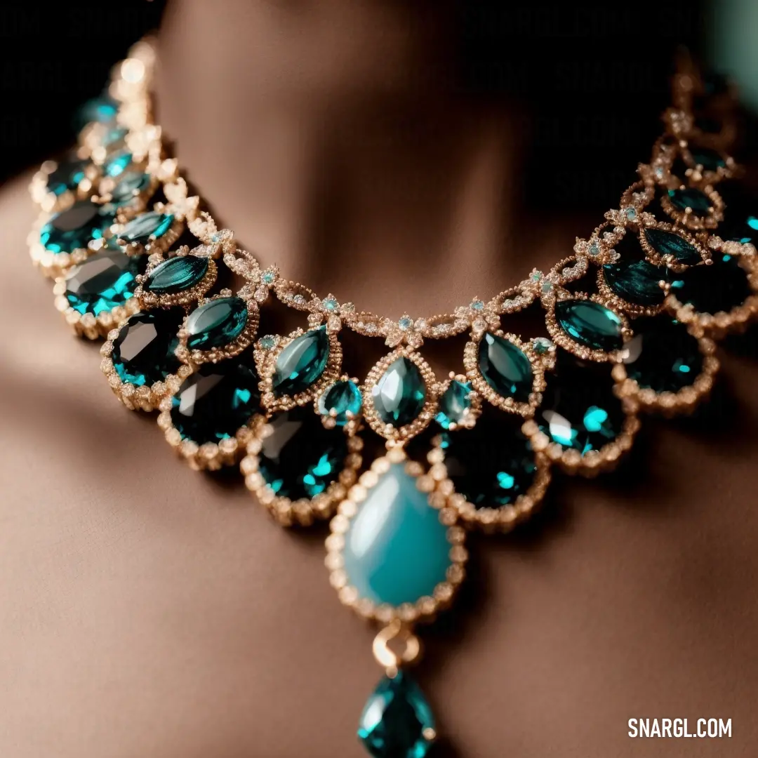 Woman wearing a necklace with green stones and a large tear drop on it's neckline