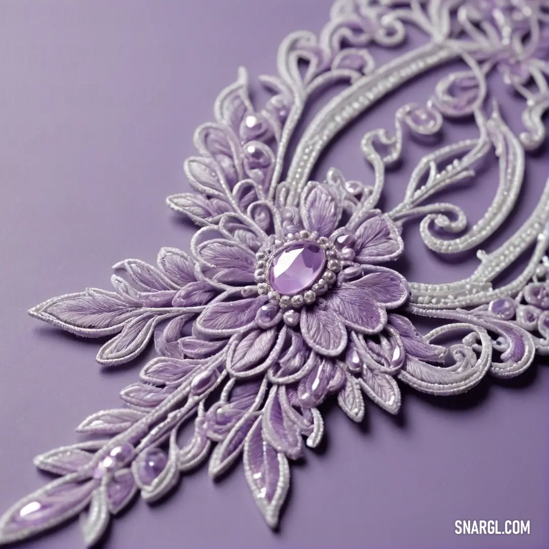 Close up of a purple and silver brooch with a flower design on it's side and a diamond center. Color #D8BFD8.