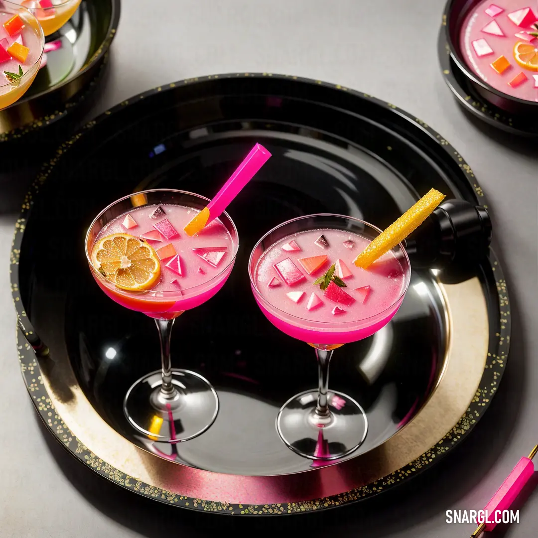 Couple of glasses of drinks on a tray with a pink straw and orange slice on top of it