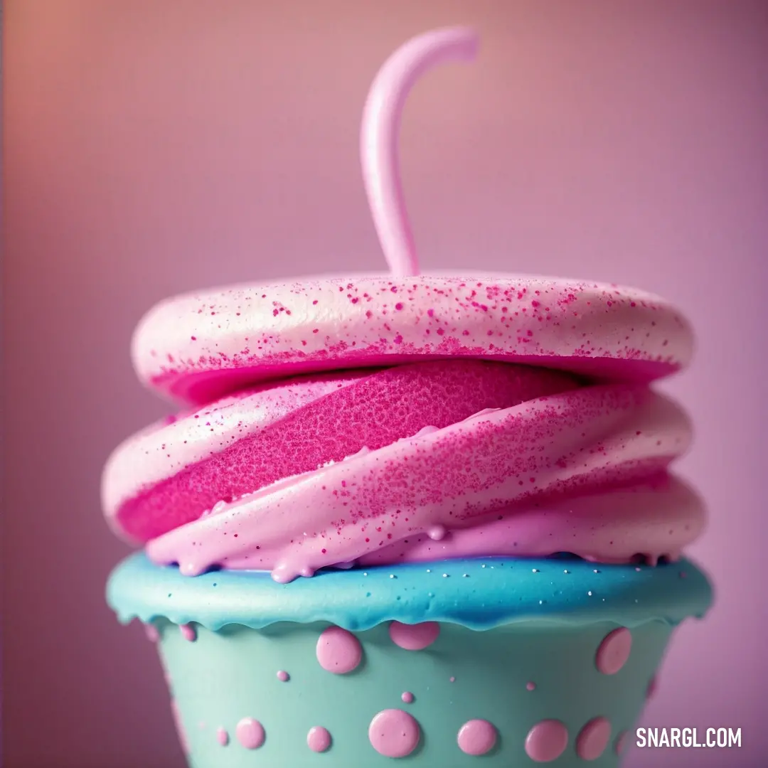 Cupcake with a pink umbrella on top of it's top layer and sprinkles