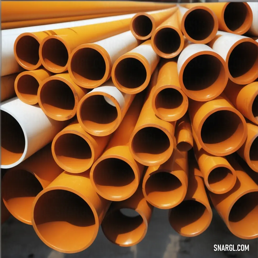 Pile of orange and white pipes stacked on top of each other in a warehouse or warehouse area. Color CMYK 0,37,73,12.