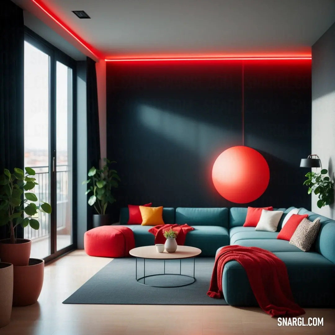 Living room with a blue couch and a red ball hanging from the ceiling and a red lamp on the wall. Color #B22222.