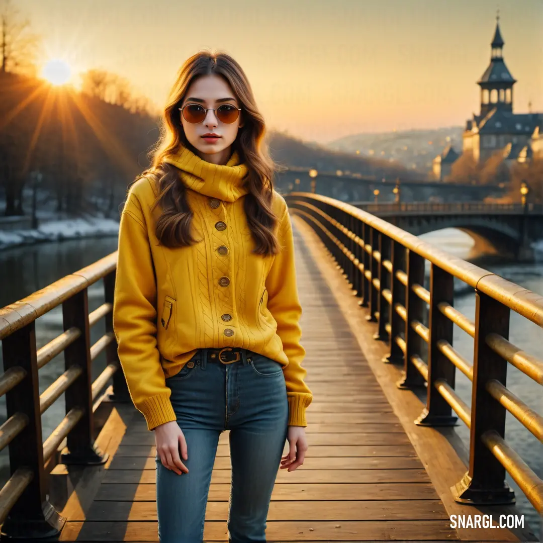 Woman standing on a bridge with a yellow sweater on and a yellow scarf around her neck