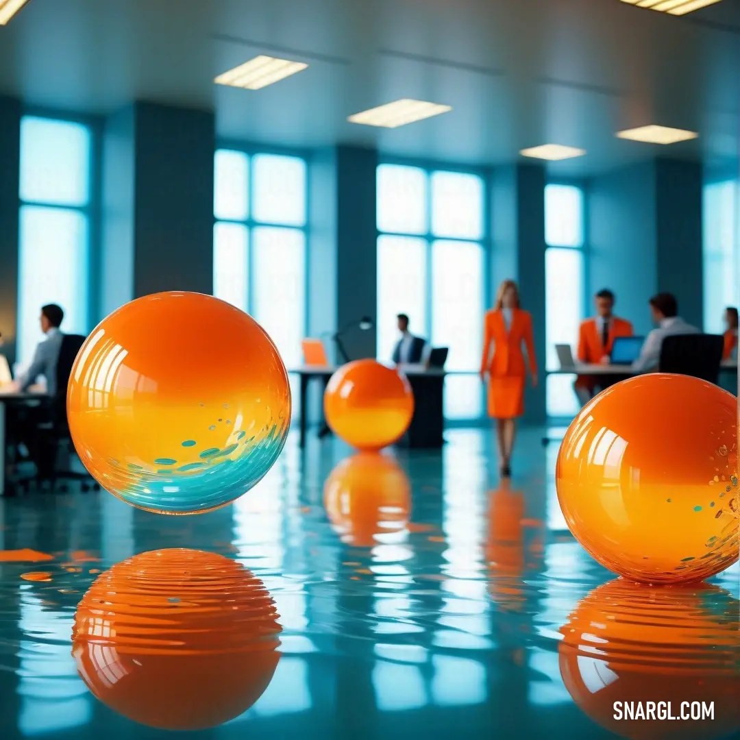 Group of people at a table in a room with orange balls on the floor and a woman standing in the background. Example of #FFB300 color.