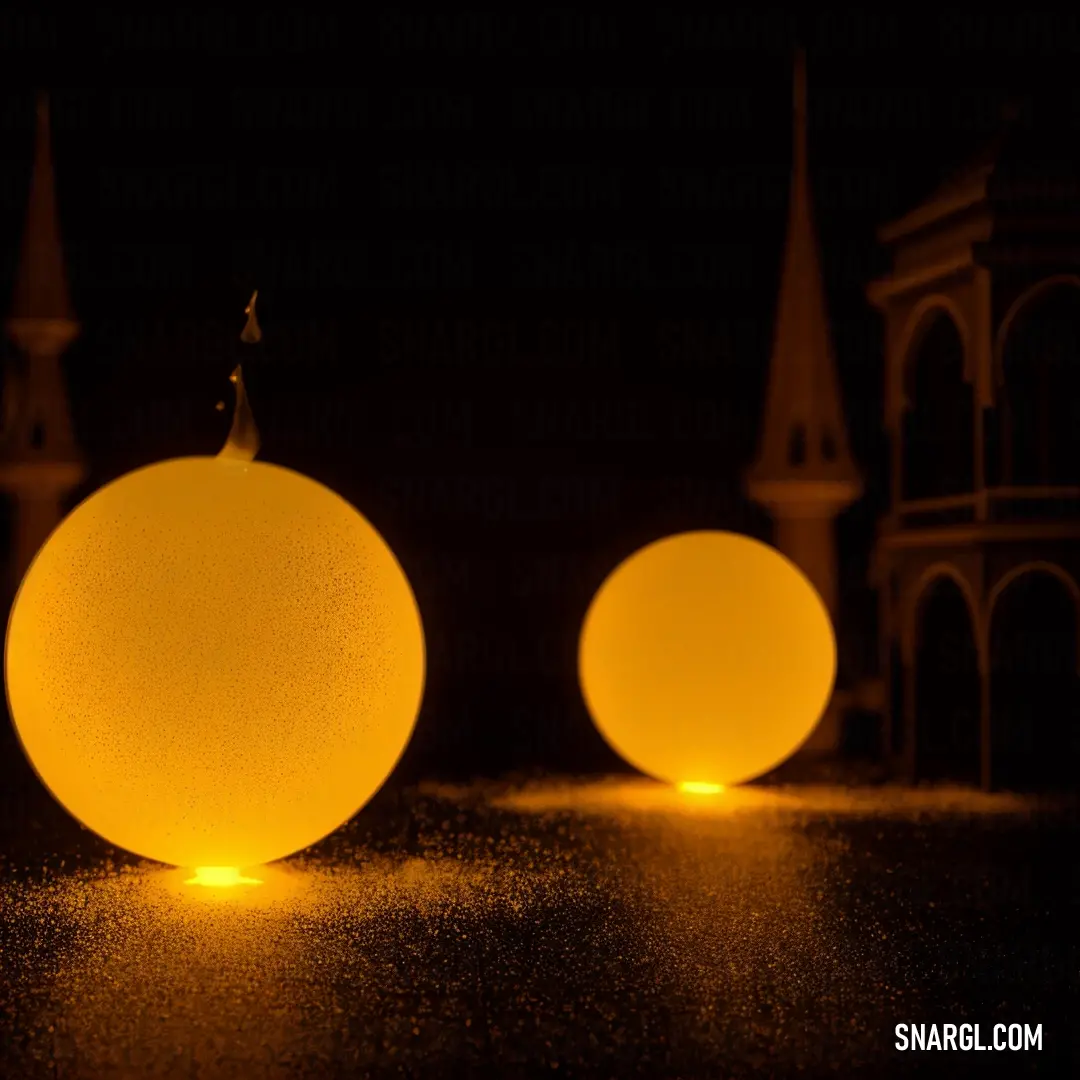 Couple of yellow balls on top of a table next to each other on a table top with a clock tower in the background