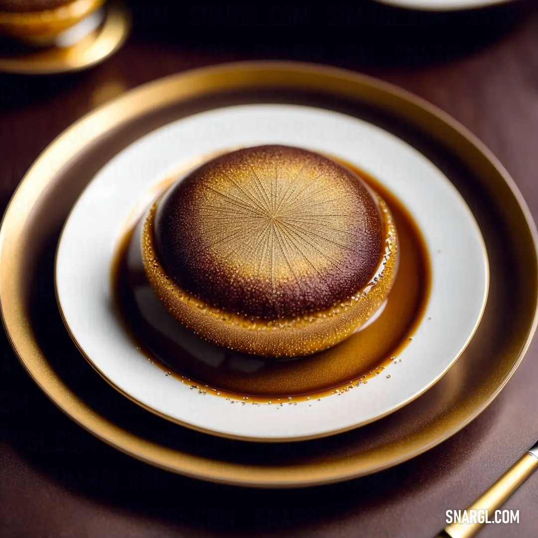 University of California Gold color. Plate with a dessert on it on a table with a fork and knife next to it