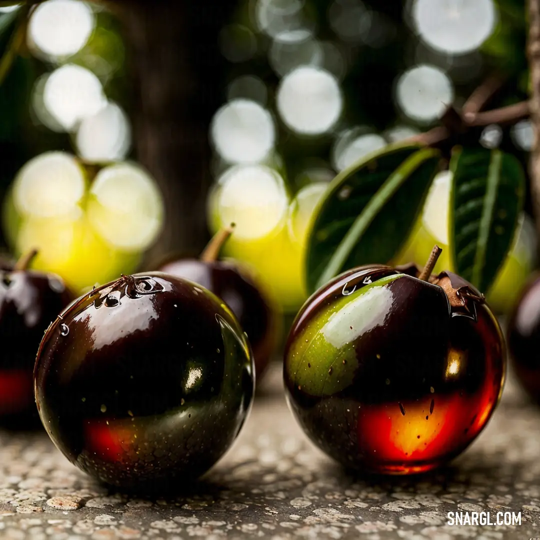 Group of cherries on top of a stone floor next to a tree with leaves on it