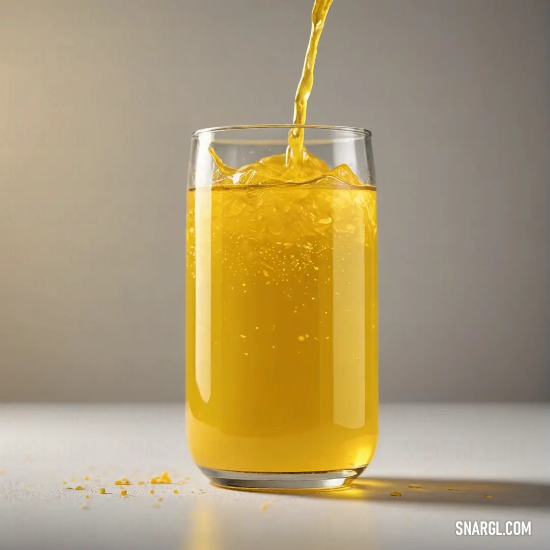 Glass filled with liquid on top of a table next to a bottle of orange juice and a spoon. Color Urobilin.