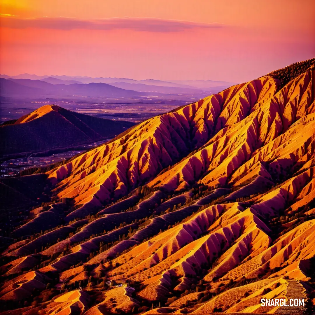 A colorful mountain landscape with a vibrant sky stretching above. The peaks stand in stark contrast to the kaleidoscope of colors in the sky, creating a breathtaking and dramatic scene.