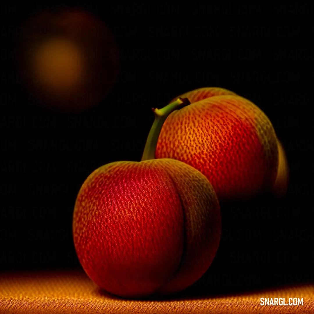 Two oranges on a table with a black background. Example of USC Cardinal color.