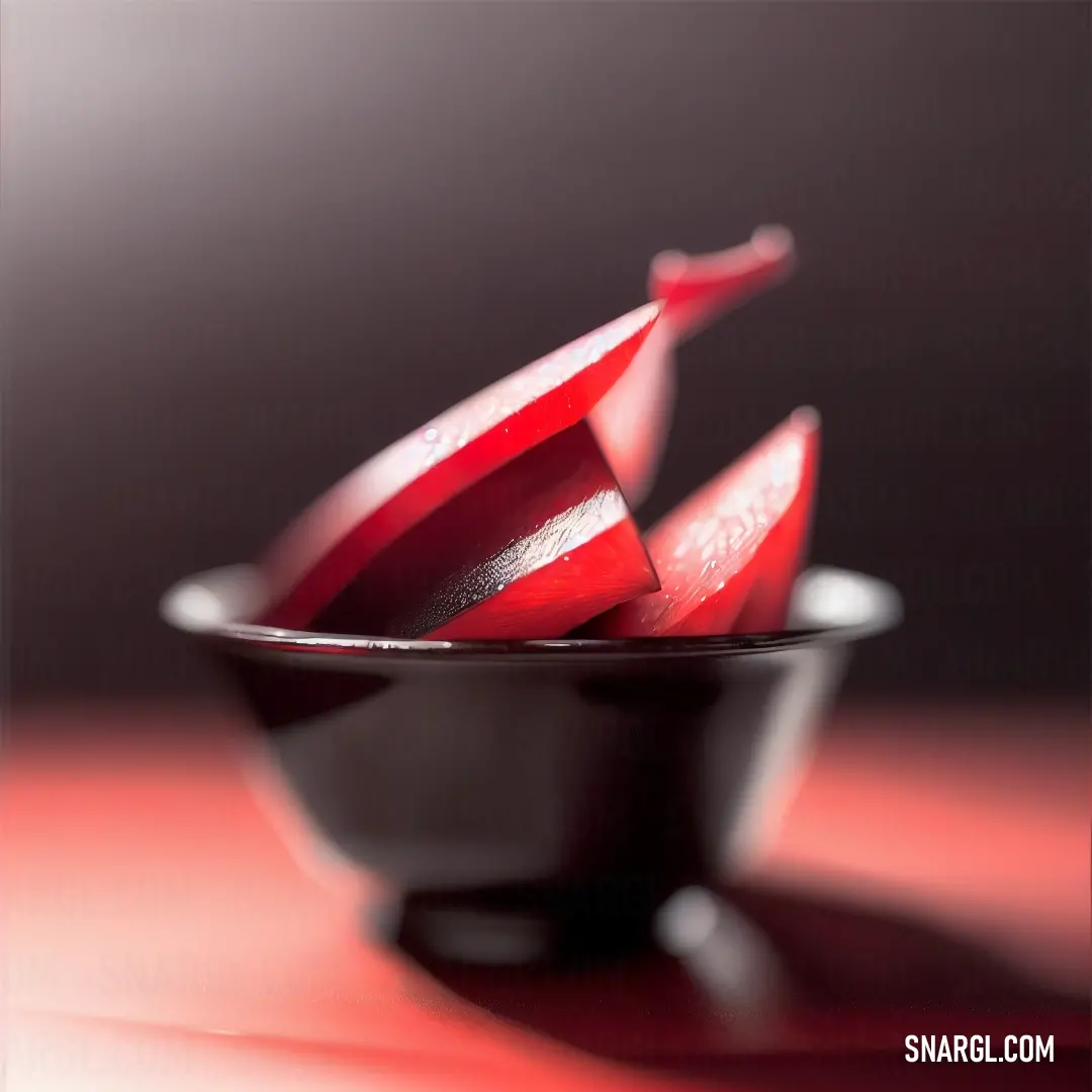 Utah Crimson color. Black bowl filled with red fruit on top of a table next to a red table cloth