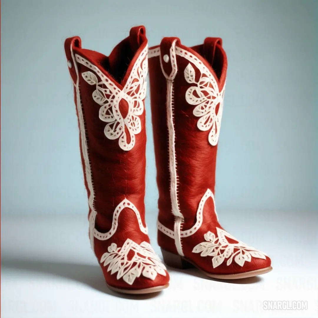 Pair of red boots with white lace on them are shown in a studio photo against a blue background. Color #C80815.