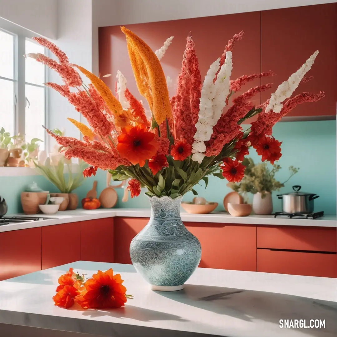 Vase with flowers on a table in a kitchen with a window in the background. Example of Venetian red color.