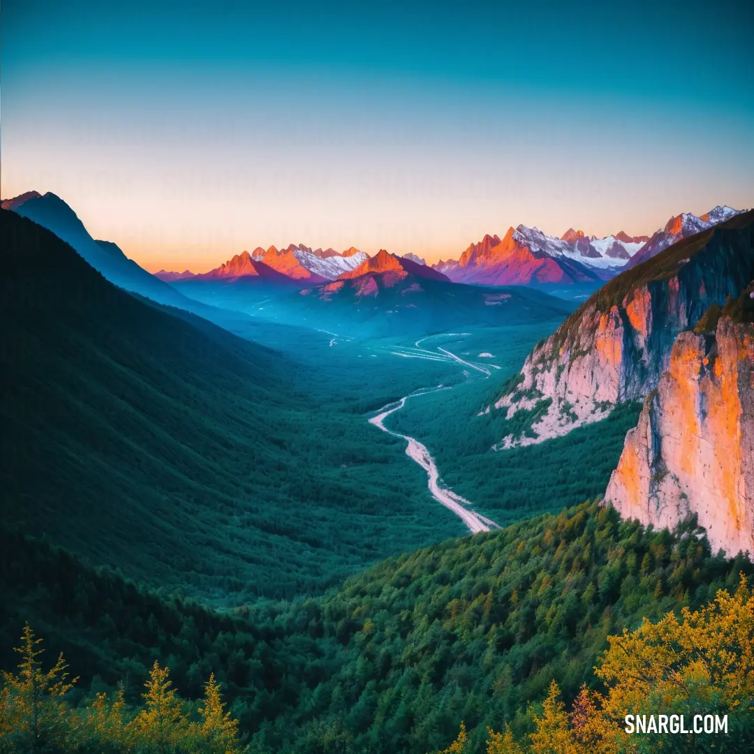 Valley with a river running through it surrounded by mountains and trees at sunset with a sky line in the background