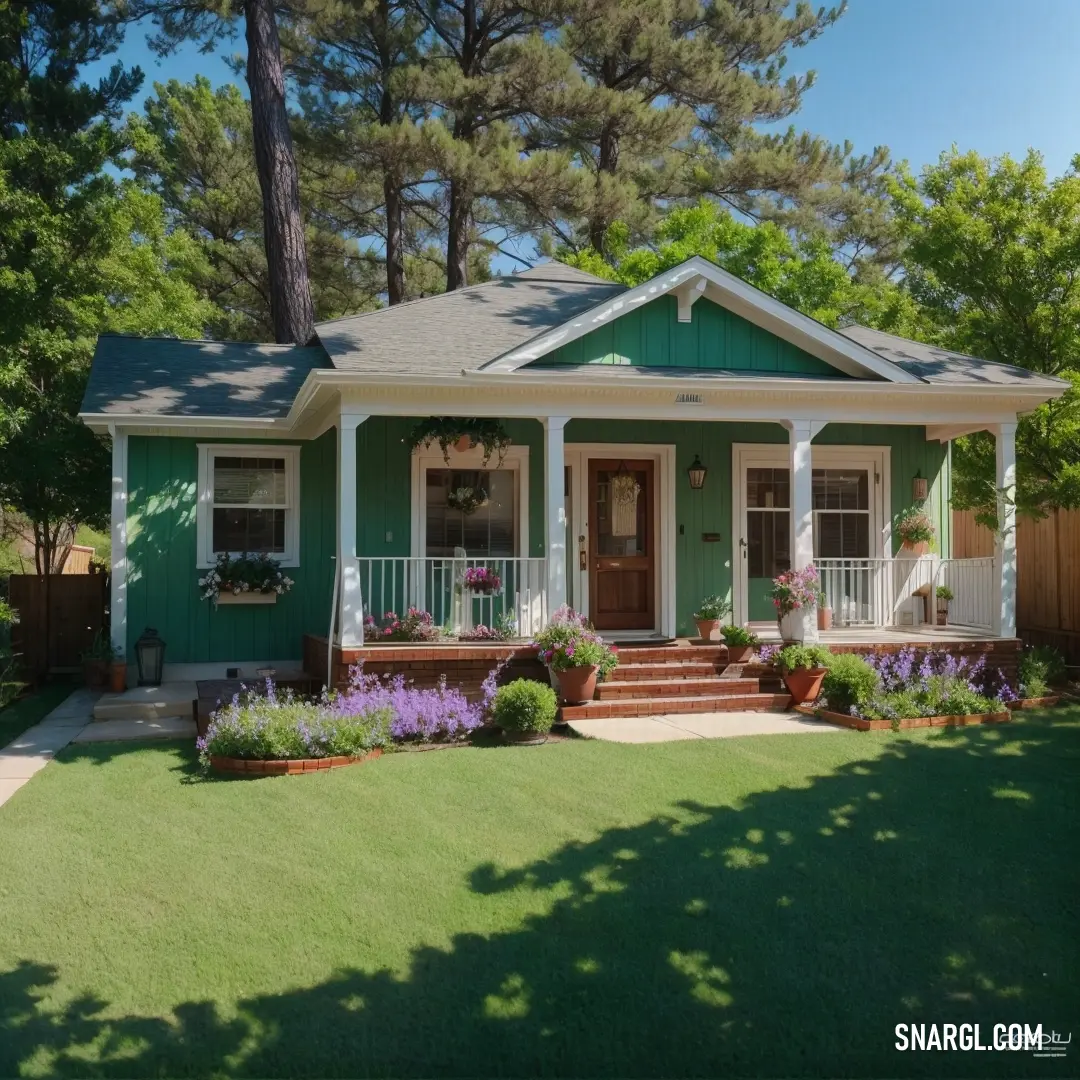 A cozy green house with a welcoming porch, surrounded by vibrant flower beds. The warm ambiance of the house blends beautifully with the colorful flowers in the garden, creating a picturesque, homely scene.