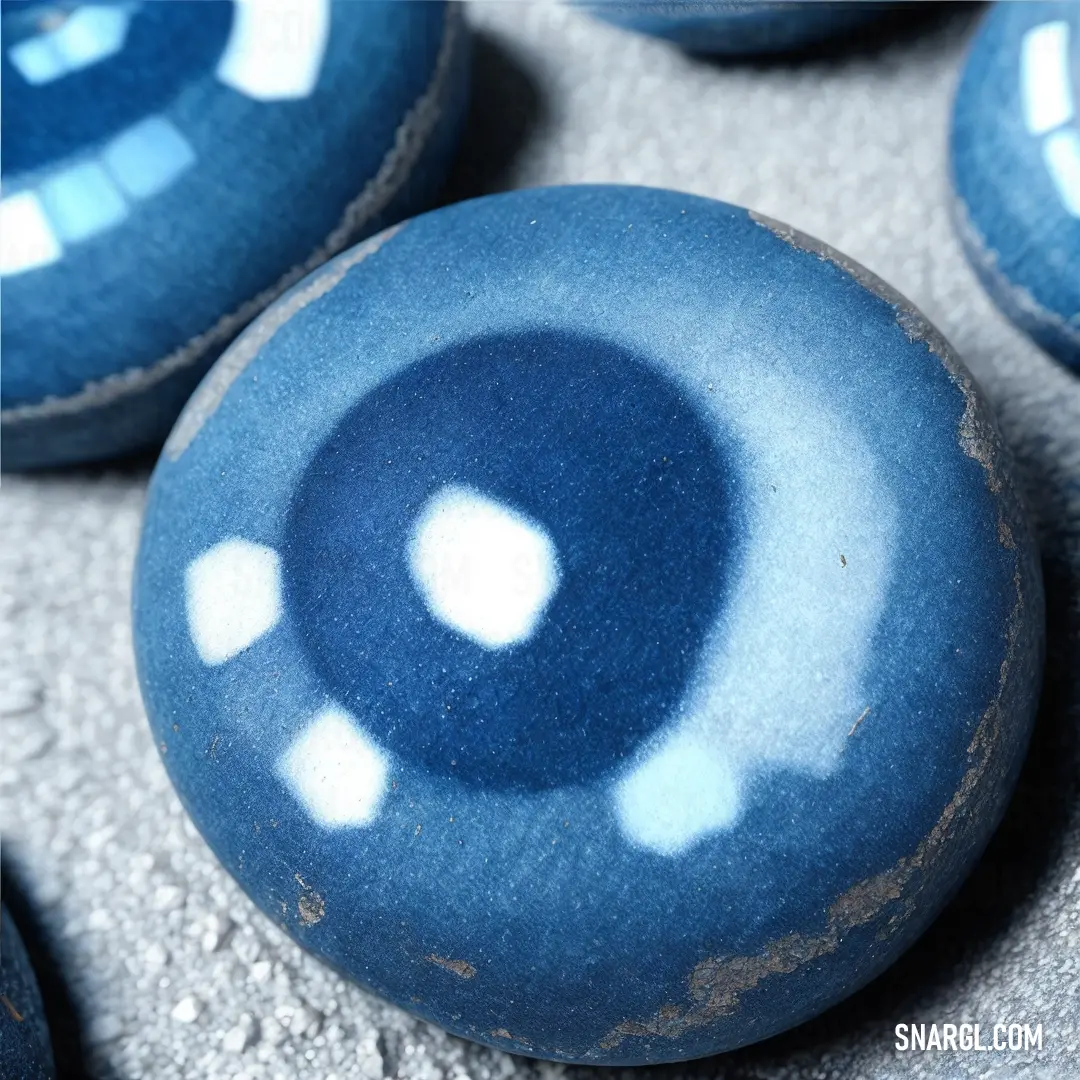 Close up of a blue and white object on a surface with other objects in the background