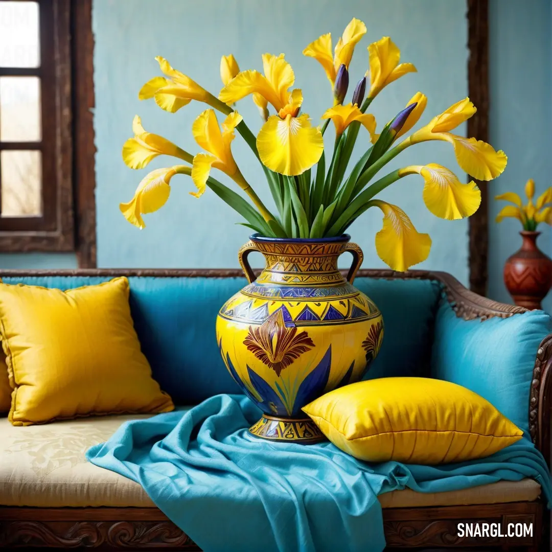 Yellow color example: Vase with yellow flowers on a couch with pillows and a blue blanket on it and a window behind it