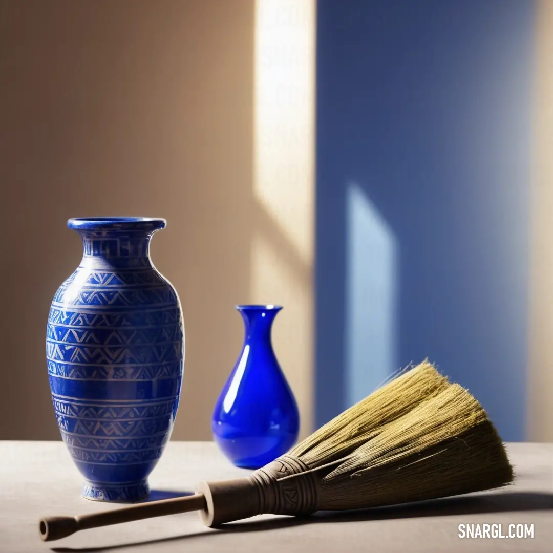 Blue vase and a broom on a table with a blue vase. Example of RGB 0,20,168 color.