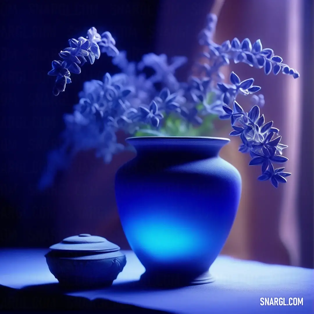 Blue vase with flowers in it on a table next to a cookie jar and a window curtain. Example of Zaffre color.