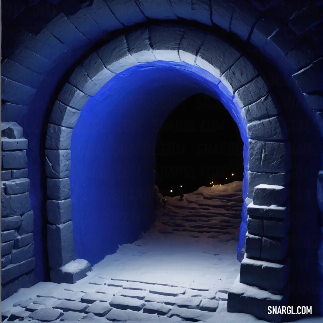 Tunnel with a snow covered pathway leading into it at night time with lights on the side of the tunnel. Example of Zaffre color.